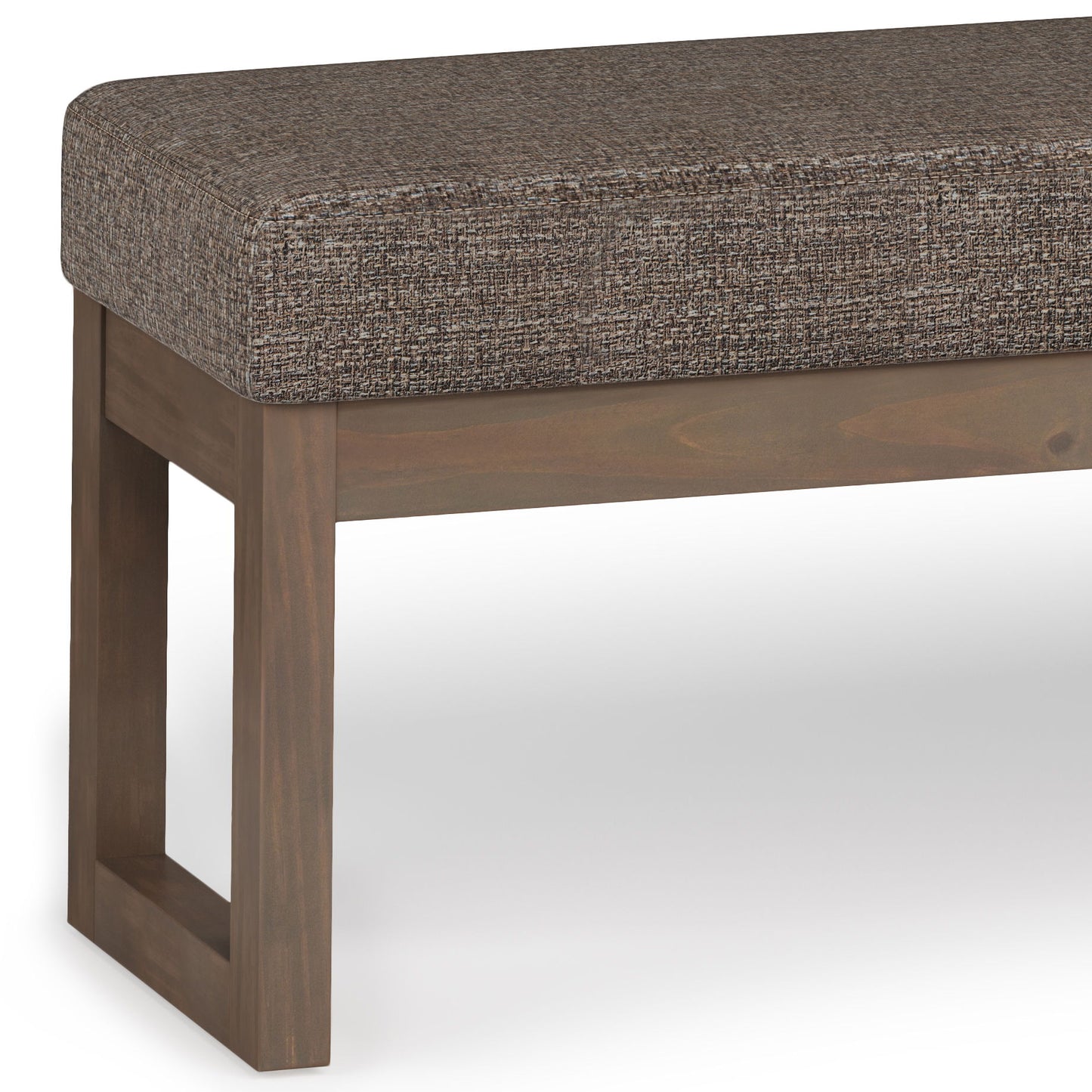 The Milltown Upholstered Ottoman Bench features a rectangular brown cushion and solid wooden legs, shown in close-up on a plain white background.