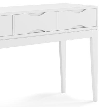The Harper Handcrafted Console Sofa Table features a white wooden finish, four drawers with curved handles, angled legs, and a modern minimalist design. The image displays a partial side view of the table.