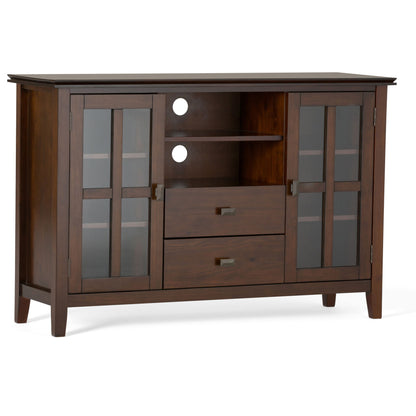 The Artisan Handcrafted Tall TV Media Stand features dark wood, two glass-paneled side cabinets, two center drawers, open shelves above, and circular cable management holes on the back panel.