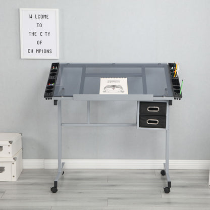 An Adjustable Art Drawing Desk Craft Station Drafting With 2 Non-Woven Fabric Slide Drawers And 4 Wheels - Silver holds an open sketchbook and art supplies. White storage boxes sit to its left, below a "WELCOME TO THE CITY OF CHAMPIONS" sign on the wall.