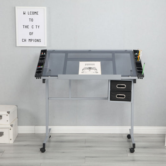 An Adjustable Art Drawing Desk Craft Station Drafting With 2 Non-Woven Fabric Slide Drawers And 4 Wheels - Silver holds an open sketchbook and art supplies. White storage boxes sit to its left, below a "WELCOME TO THE CITY OF CHAMPIONS" sign on the wall.