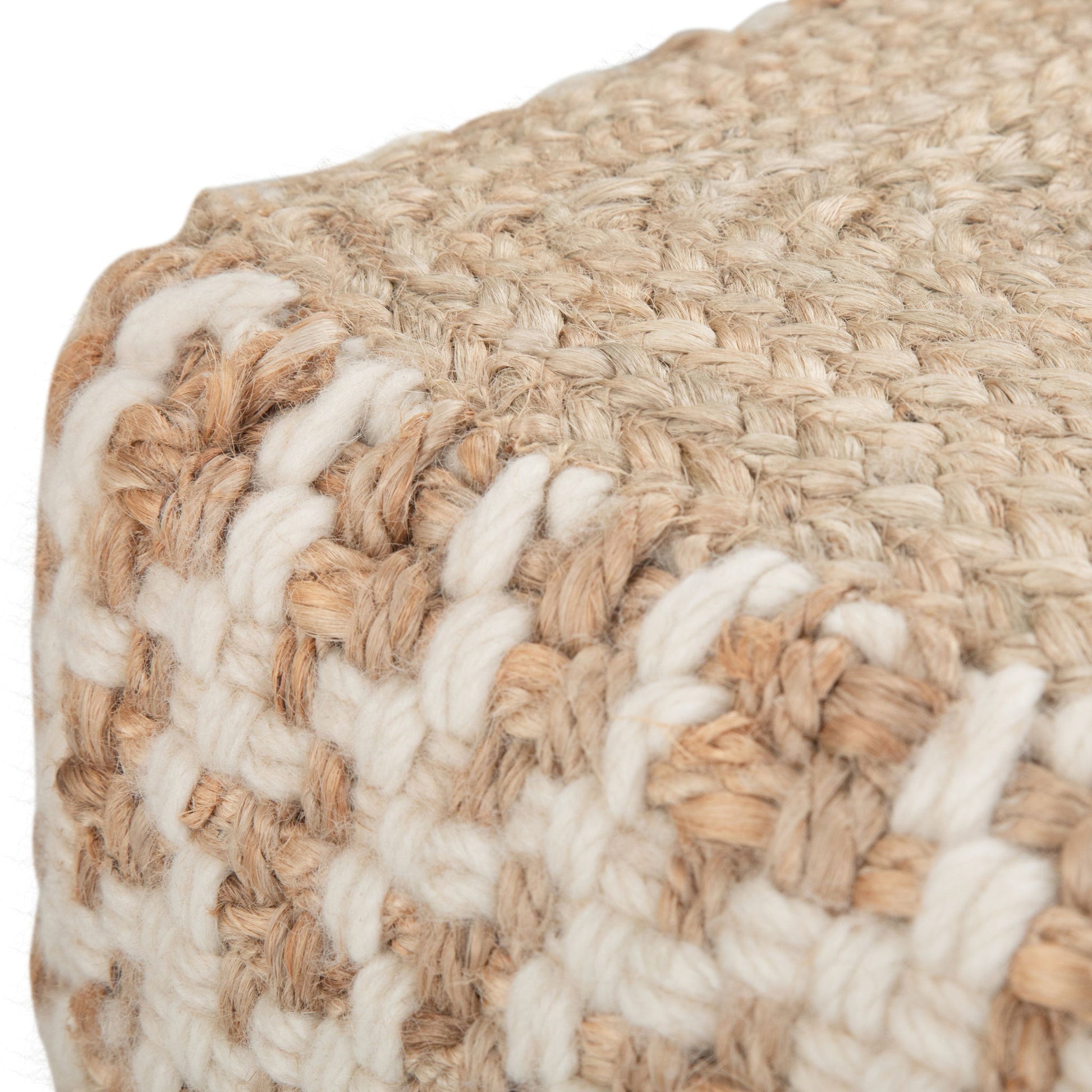 Close-up of the Cullen - Cube Pouf - Natural, featuring thick beige and white yarn woven into a chunky knit pattern on the corner. The sturdy, textured fabric highlights its natural appeal.