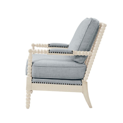 Side view of the Arm Chair With Open Back Spindle Design, featuring light blue cushions, padded armrests, a white wooden frame with spindle-shaped details, and decorative nailhead trim along the arms and base.