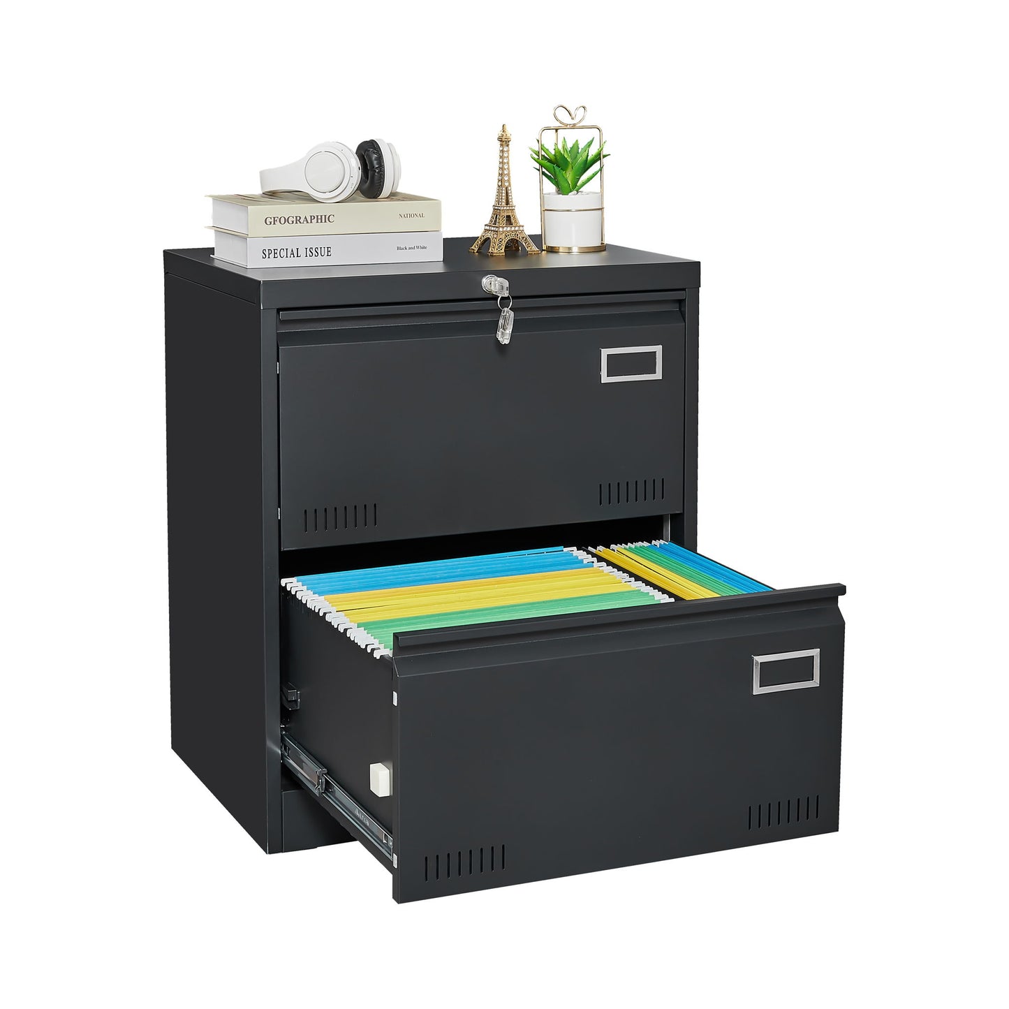 The 2 Drawer Metal Lateral File Cabinet With Lock in black features a closed, locked top drawer and an open bottom drawer with colorful folders. The top holds books, headphones, a small Eiffel Tower, and a potted plant—ideal for home offices.