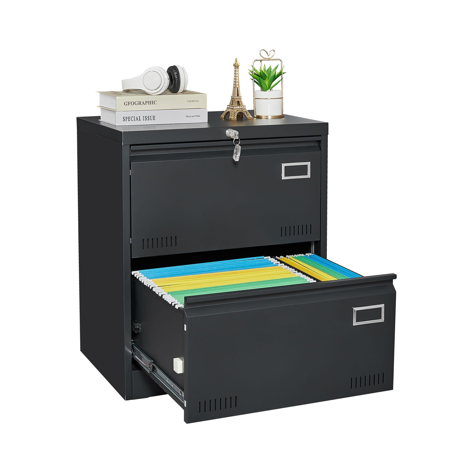 The 2 Drawer Metal Lateral File Cabinet With Lock in black features a closed, locked top drawer and an open bottom drawer with colorful folders. The top holds books, headphones, a small Eiffel Tower, and a potted plant—ideal for home offices.