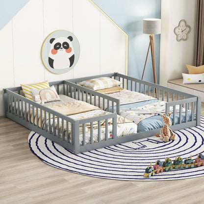 A children’s bedroom with two gray Double Floor Beds With Fence, side by side, a circular blue-and-white rug, plush giraffe toy, panda wall art, a floor lamp, and a wooden train toy on the floor.