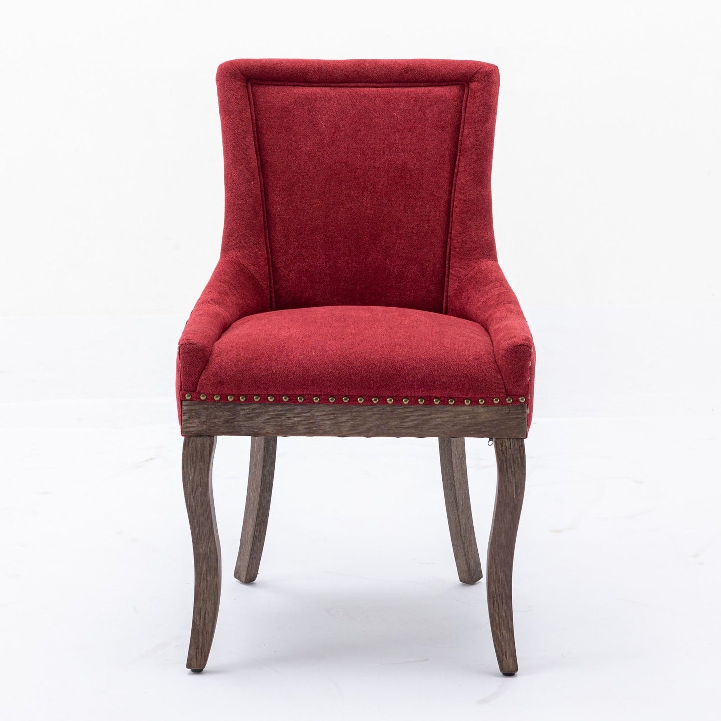 The Ultra Side Dining Chair set features thickened fabric in a plush, red upholstery, tall backrests, neutrally toned solid wood legs, and bronze nailhead trim along the bottom edge, displayed against a plain white background.