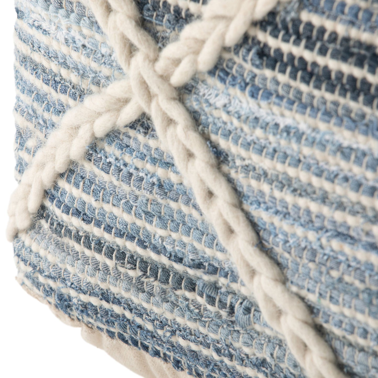 Close-up of the Cowan - Handcrafted Square Pouf, featuring blue and white woven fabric with thick cream braided yarn forming an "X" pattern. The soft, detailed texture adds a cozy touch to any room.