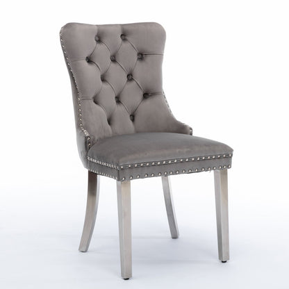 The Nikki dining chair set features modern, high-end velvet upholstery, a tufted backrest, chrome stainless steel plated legs, and nailhead trim for an elegant look. Sold as a set of 2.