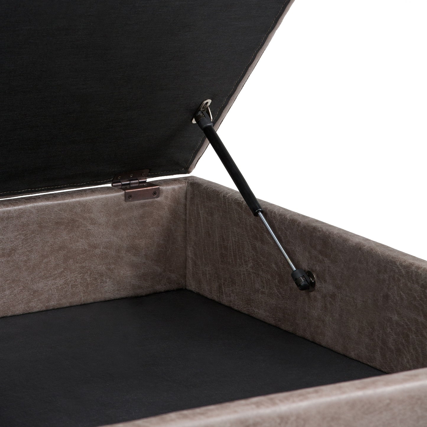 Close-up of the Owen Multifunctional Square Coffee Table Storage Ottoman's inside corner, featuring a hinged lid with black gas lift support, dark fabric lining, and a textured grayish-brown exterior.