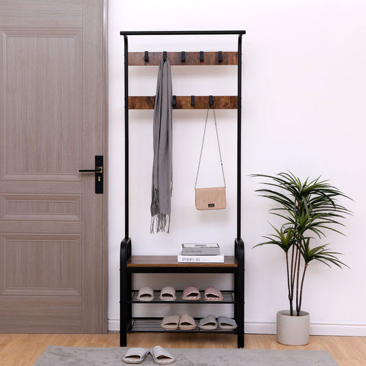 A hallway entryway features the Hall Tree With Shoe Bench For Entryway With 9 Removable Hooks, holding a gray scarf and beige purse, plus books on the bench, a potted plant, and shelves below with six pairs of slippers on a rug by a closed door.