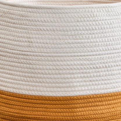 Close-up of the Francis - Cotton Round Laundry and Storage Basket, showcasing its textured woven surface with a thick white band on top and a wide golden-brown band at the bottom.