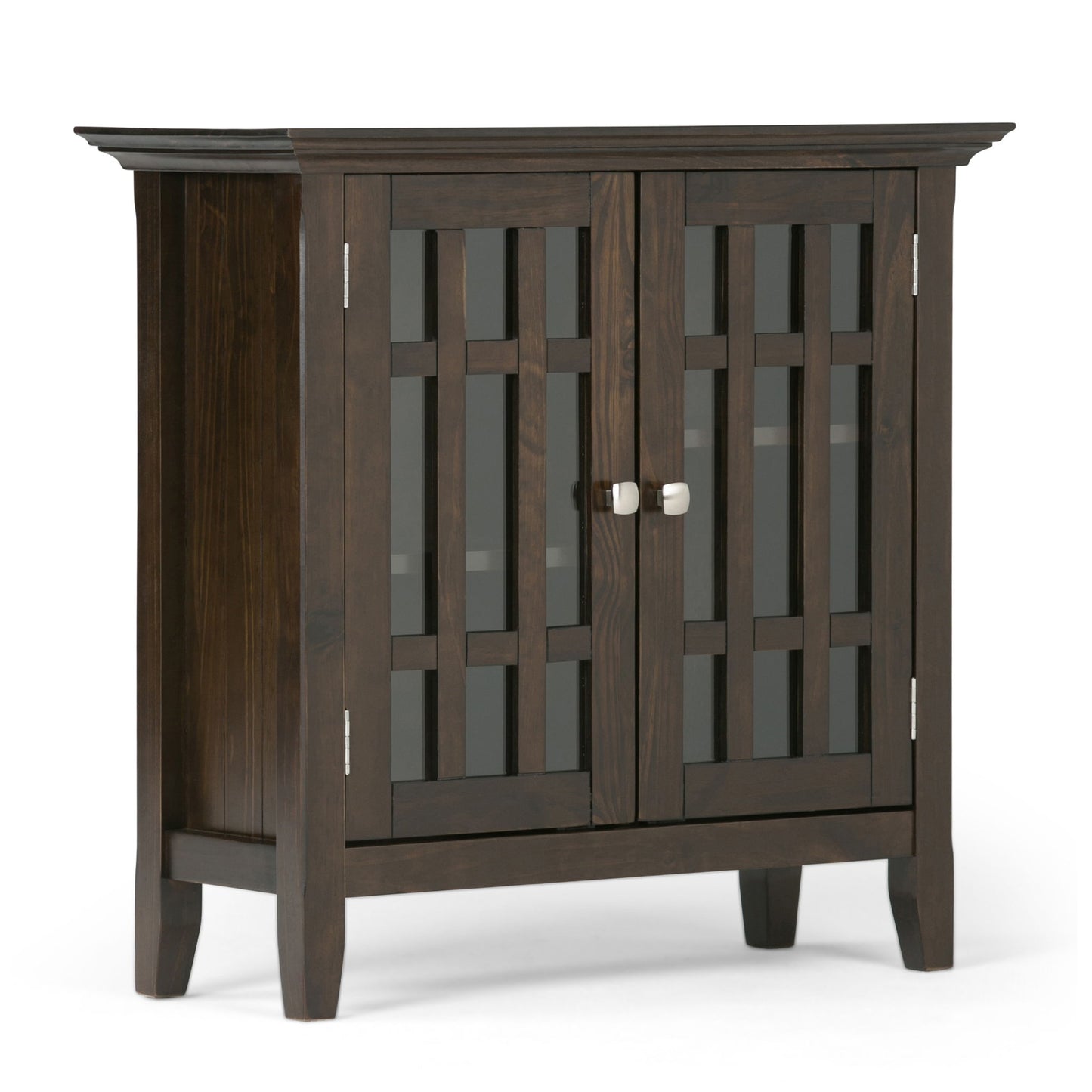 The Bedford - Storage Media Cabinet is a dark wood unit with glass-paneled double doors that have grid patterns, silver hinges, round handles, and stands on four short legs.