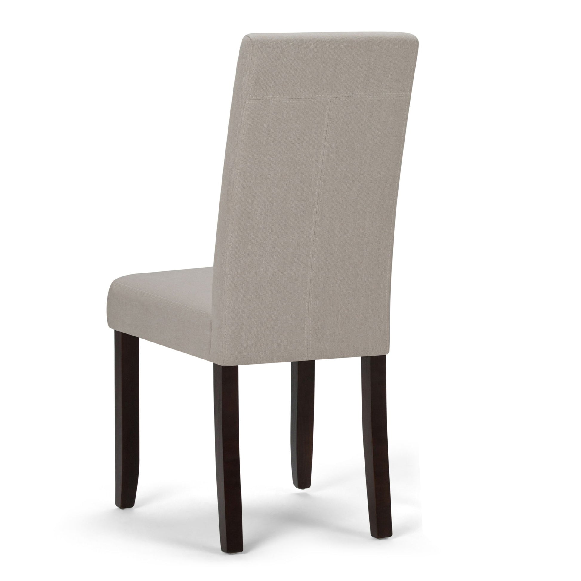 The Acadian Upholstered Parson Dining Chair (Set of 2) features a beige high backrest and dark wooden legs, shown from a rear side angle against a white background.