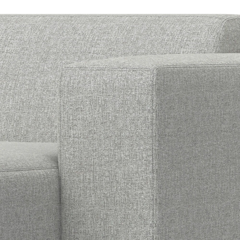 Close-up of the corner and armrest of the Rex - Right Chaise Sofa Module in gray, featuring a modern boxy design with textured upholstery.