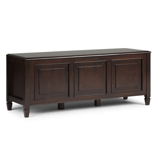 The Connaught - Handcrafted Storage Bench Trunk features a dark brown wood finish, three paneled front doors, short tapered legs, and a smooth rectangular top for stylish storage.