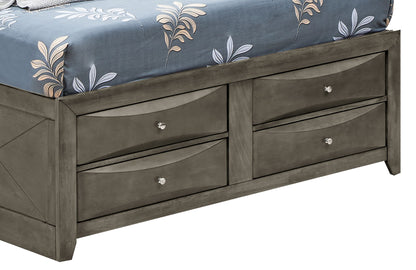 The Marilla Storage Bed With Bookcase Headboard features four built-in drawers with round metal knobs and is shown topped with a blue, leaf-patterned comforter.