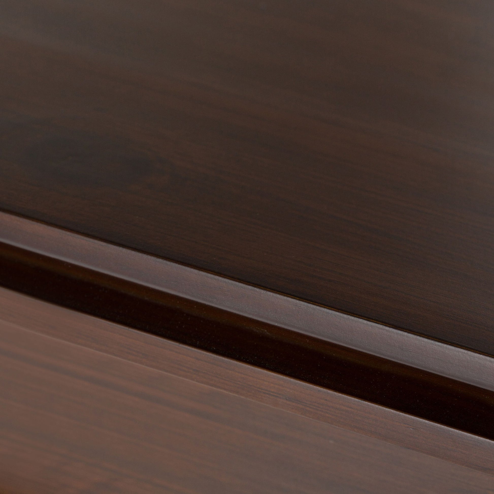 Close-up of the Artisan - Handcrafted Sideboard Buffet, showcasing polished dark brown wood surfaces with visible grain and a subtle groove separating two panels.