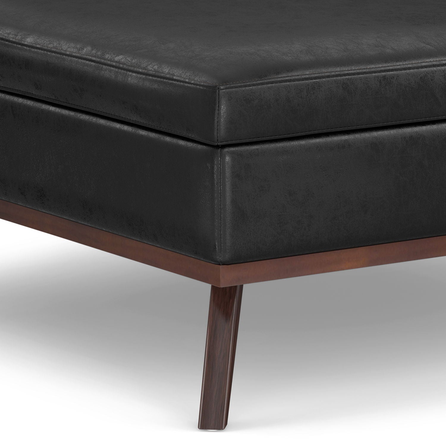 Close-up of the Owen - Multifunctional Square Coffee Table Storage Ottoman, featuring a black leather finish with a wooden frame and tapered wooden legs, set against a white background.