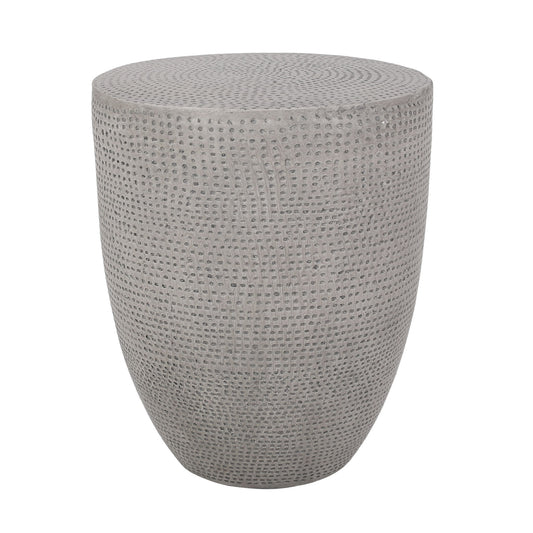 The Outdoor Lightweight Concrete Side Table in Natural features a round, gray design with a textured, dotted surface and smooth, curved silhouette, shown against a white background.