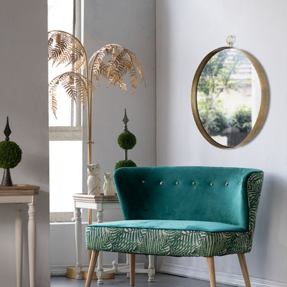 A modern room featuring a teal and green bench, potted topiary plants, a gold palm decor, an owl figurine, and the Round Mirror—Circle Mirror With Iron Frame—for living room or entryway by a sunlit window.