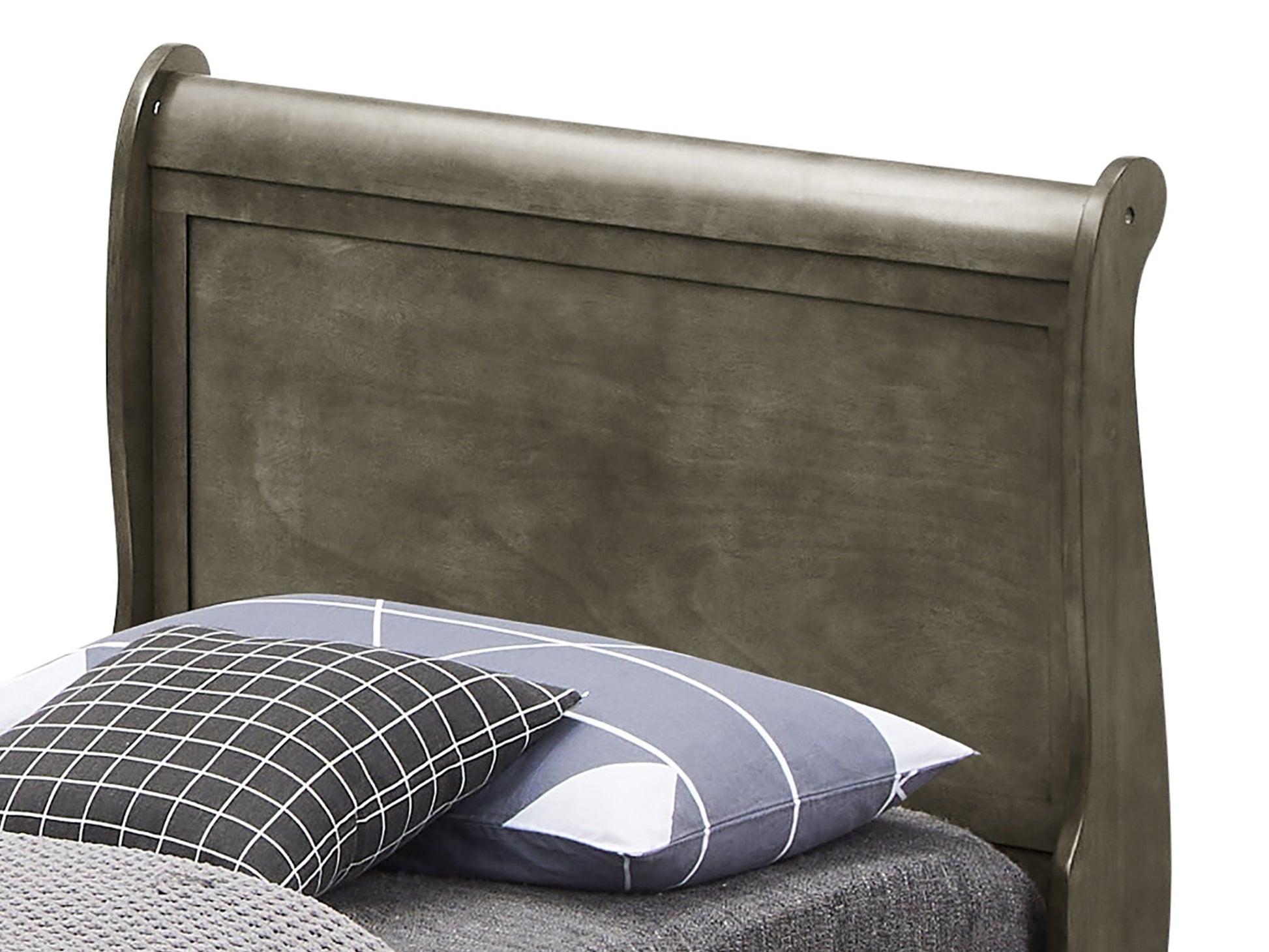 The Louis Phillipe - Storage Bed showcases a sleigh-style headboard and gray finish, styled with gray bedding plus two pillows—one checkered, one striped.