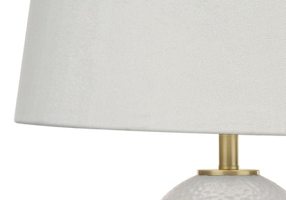 Close-up of a Lighting Table Lamp in transitional style, featuring a textured white ceramic base and plain white fabric lampshade.