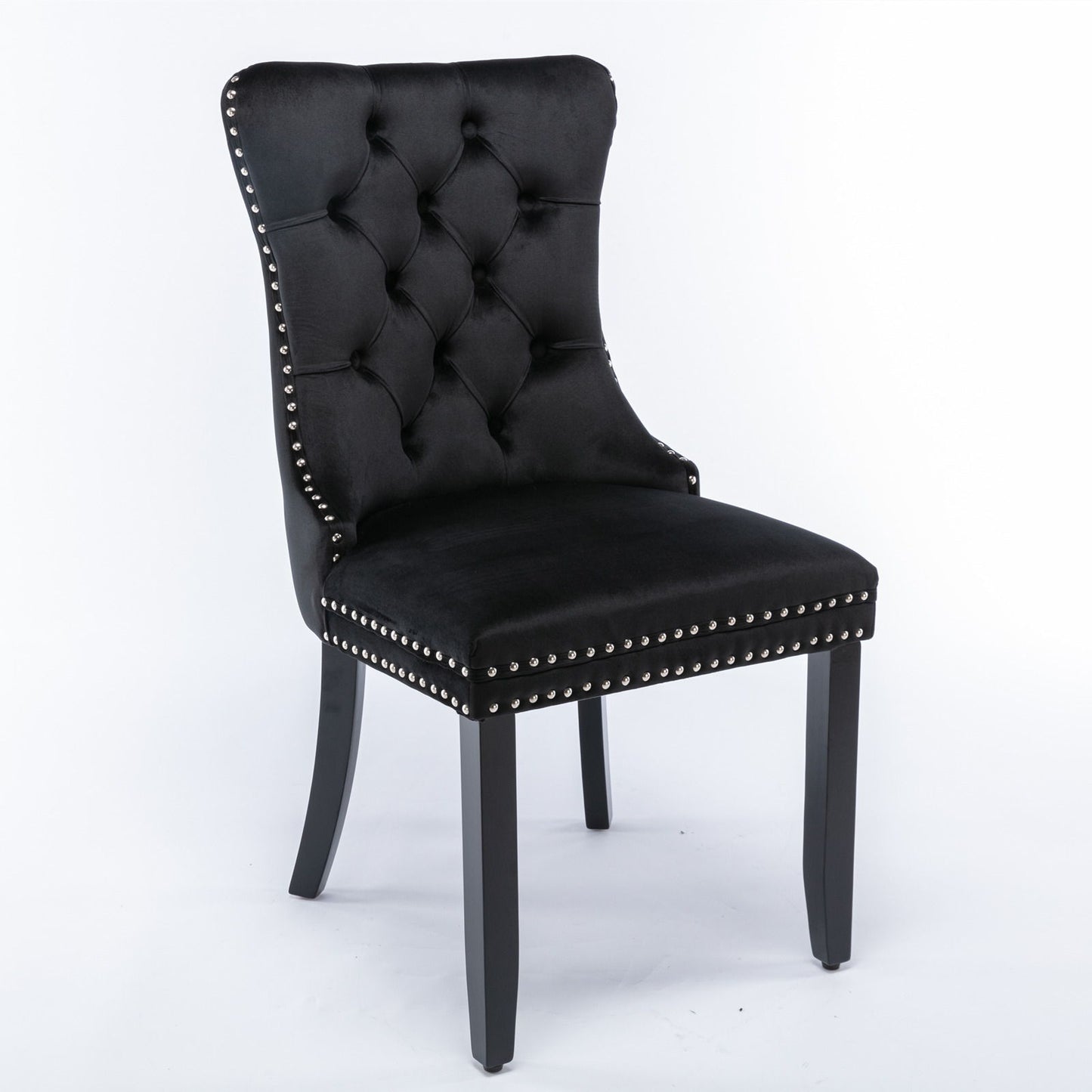The Nikki set features modern, high-end velvet upholstered dining chairs with tufted backs, silver nailhead trim, and dark solid wood legs, shown against a white background. Set includes 2 contemporary chairs.