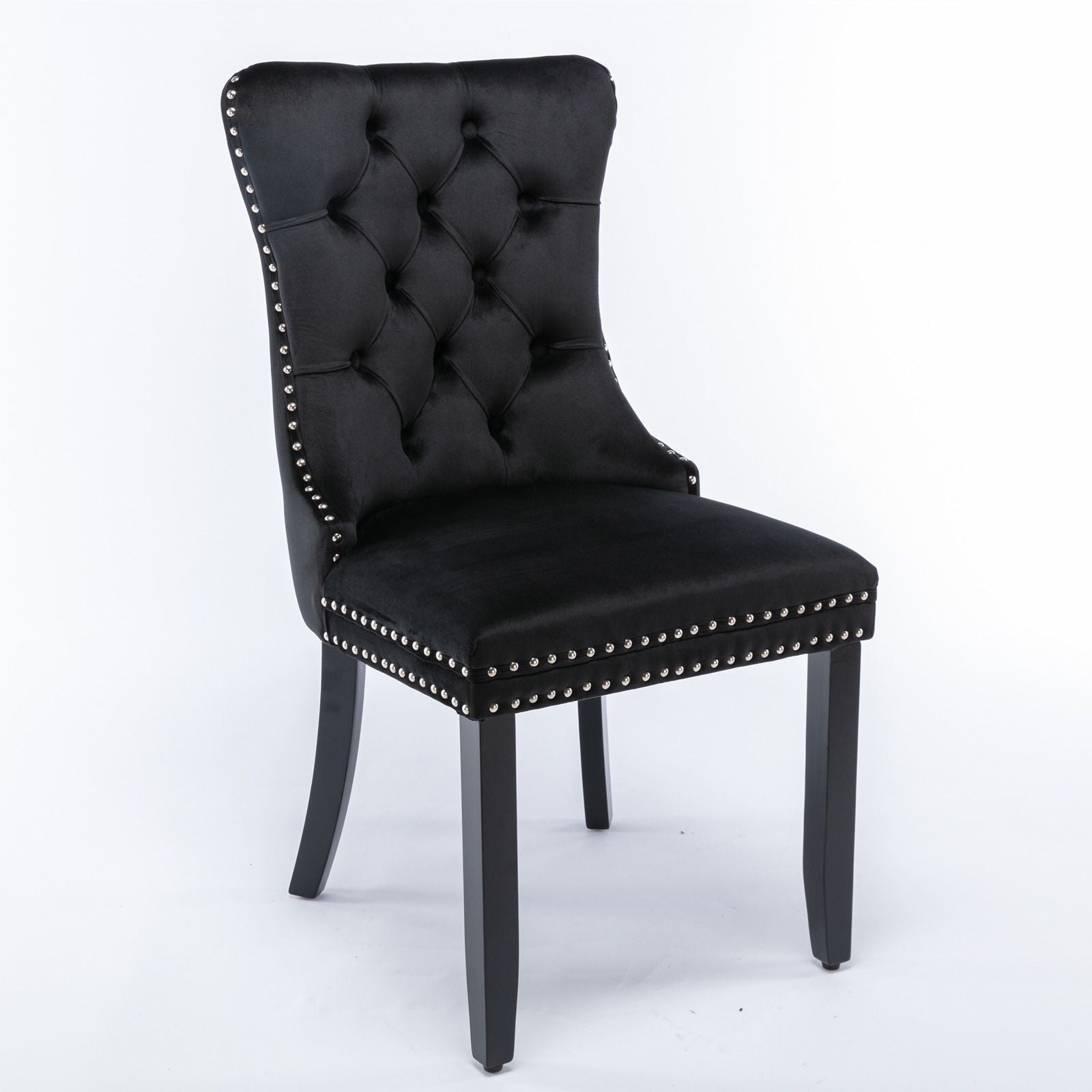 The Nikki set features modern, high-end velvet upholstered dining chairs with tufted backs, silver nailhead trim, and dark solid wood legs, shown against a white background. Set includes 2 contemporary chairs.