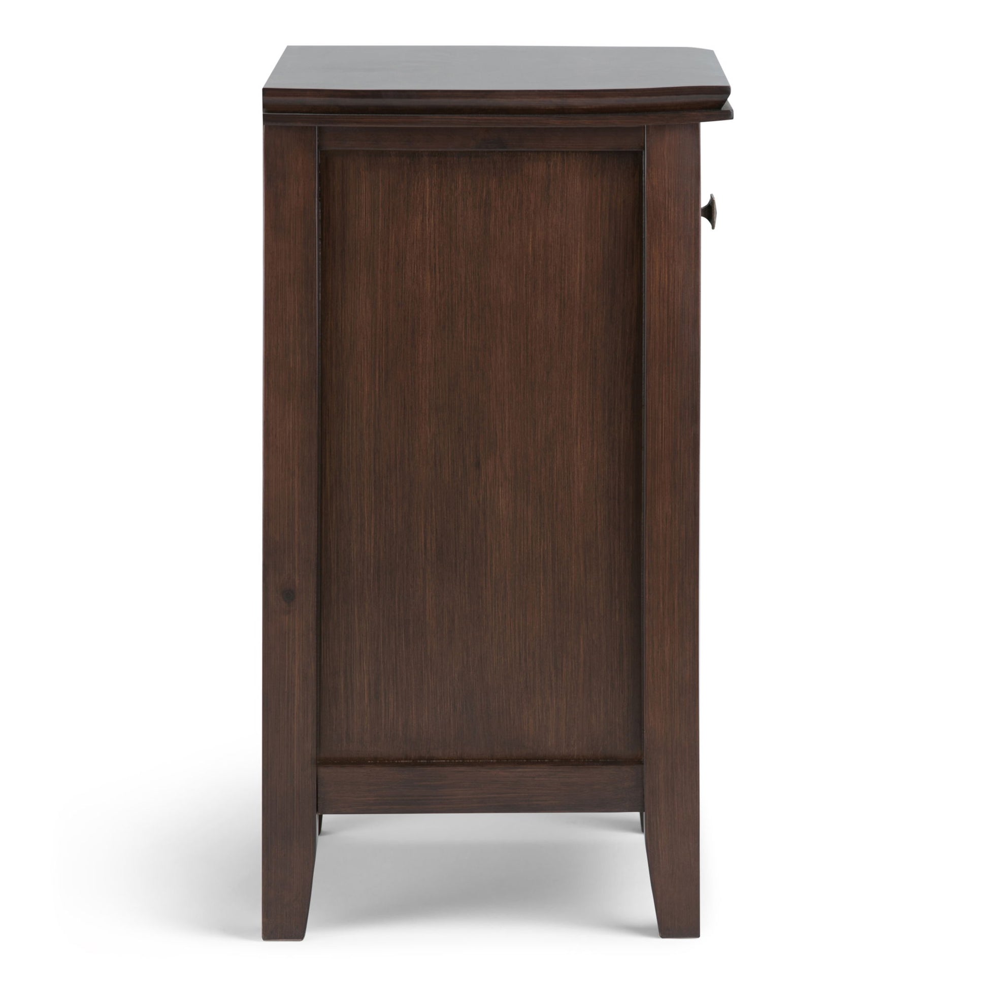 Side view of the Artisan - Handcrafted Bedside Table in dark brown wood, featuring a flat top, simple panel design, small round knob on the right edge, and four short legs.