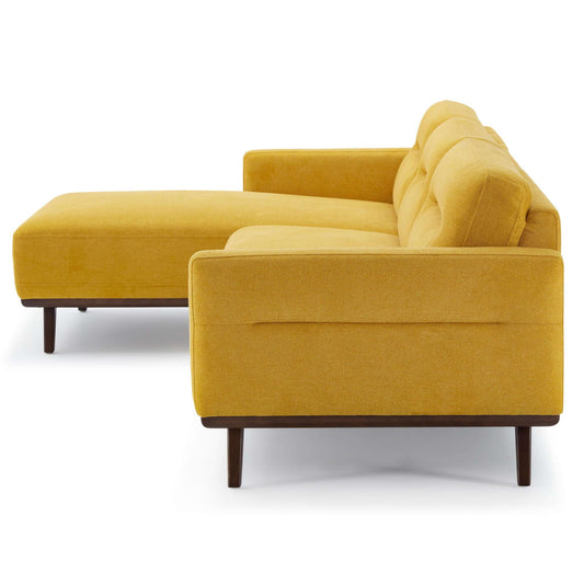 The Ella L-Shaped Sectional Couch features a modern mustard yellow design with wooden legs, left-side chaise lounge, and tufted cushions, shown from an angle highlighting the back and side.
