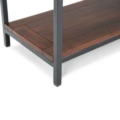 Close-up of a Skyler - Handcrafted Table shelf corner featuring dark metal legs and a richly finished brown wooden shelf. The modern, sturdy design highlights clean lines and quality materials.