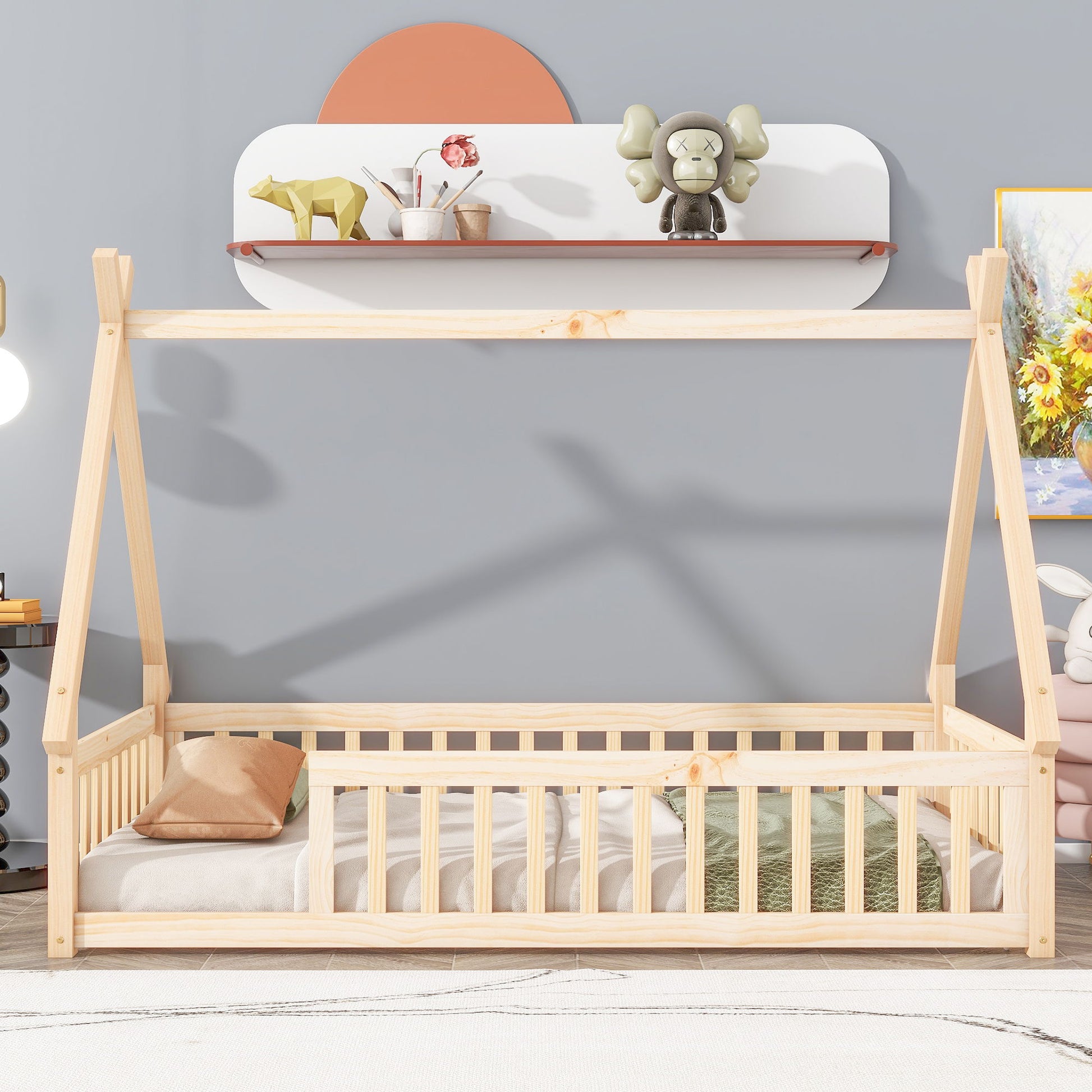 A Tent-Shaped Floor Bed with guardrails and slats is placed by a light gray wall. Above it, a shelf displays décor such as a green elephant figure, books, and a toy animal. A pillow lies on the bed.