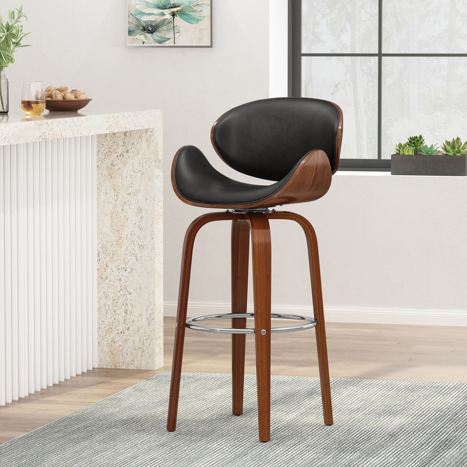 The Lumos - Mid Century Modern Upholstered Swivel Barstool, featuring curved wooden legs and a black cushioned seat and backrest, is placed on a gray rug in a bright room with a window, plants, and a small bar counter.