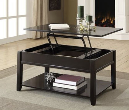 The Malachi Coffee Table With Lift Top in Black features a partially raised lift-top revealing interior storage. Books and decor rest on the lower shelf, while candles and a book sit atop. A fireplace appears in the background.