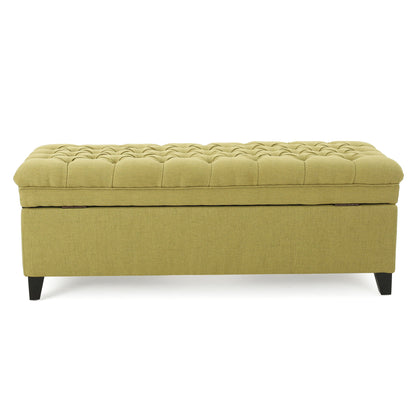 The Juliana Storage Ottoman features a rectangular olive green upholstered design, a tufted cushion top, and short angled birch legs.