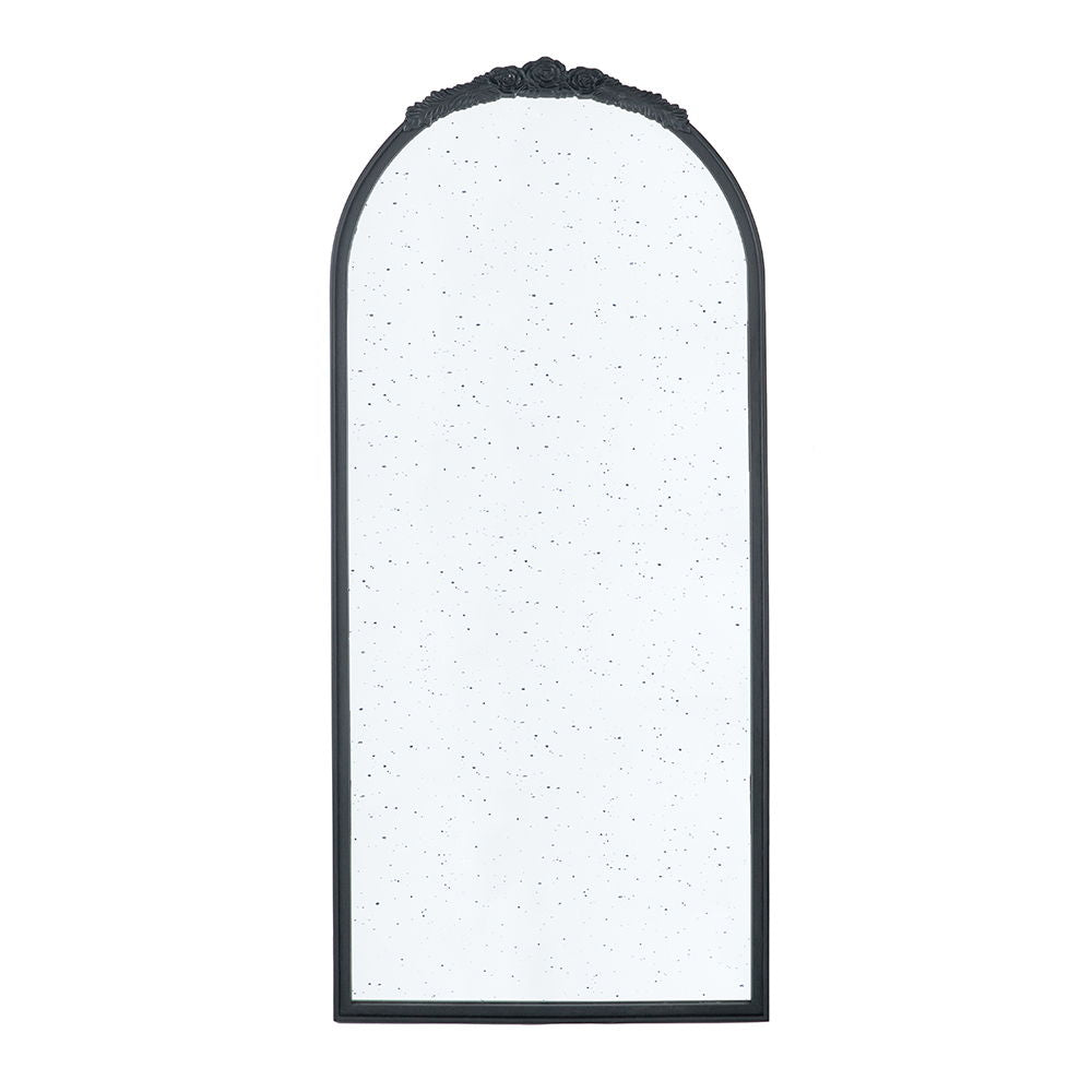 The Hand Carved Rose Antique Mirror features a wood arch frame, black finish, speckled antique-style glass, and a decorative floral detail at the top—perfect wall decor for your living room.