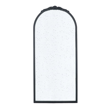The Hand Carved Rose Antique Mirror features a wood arch frame, black finish, speckled antique-style glass, and a decorative floral detail at the top—perfect wall decor for your living room.