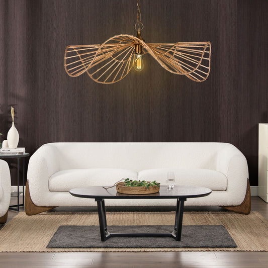 A modern living room featuring the Alpine Luxurious Upholstery Sherpa Sofa, paired with a black oval coffee table, textured brown area rug, and a sculptural rattan pendant light against a dark wood-paneled wall.