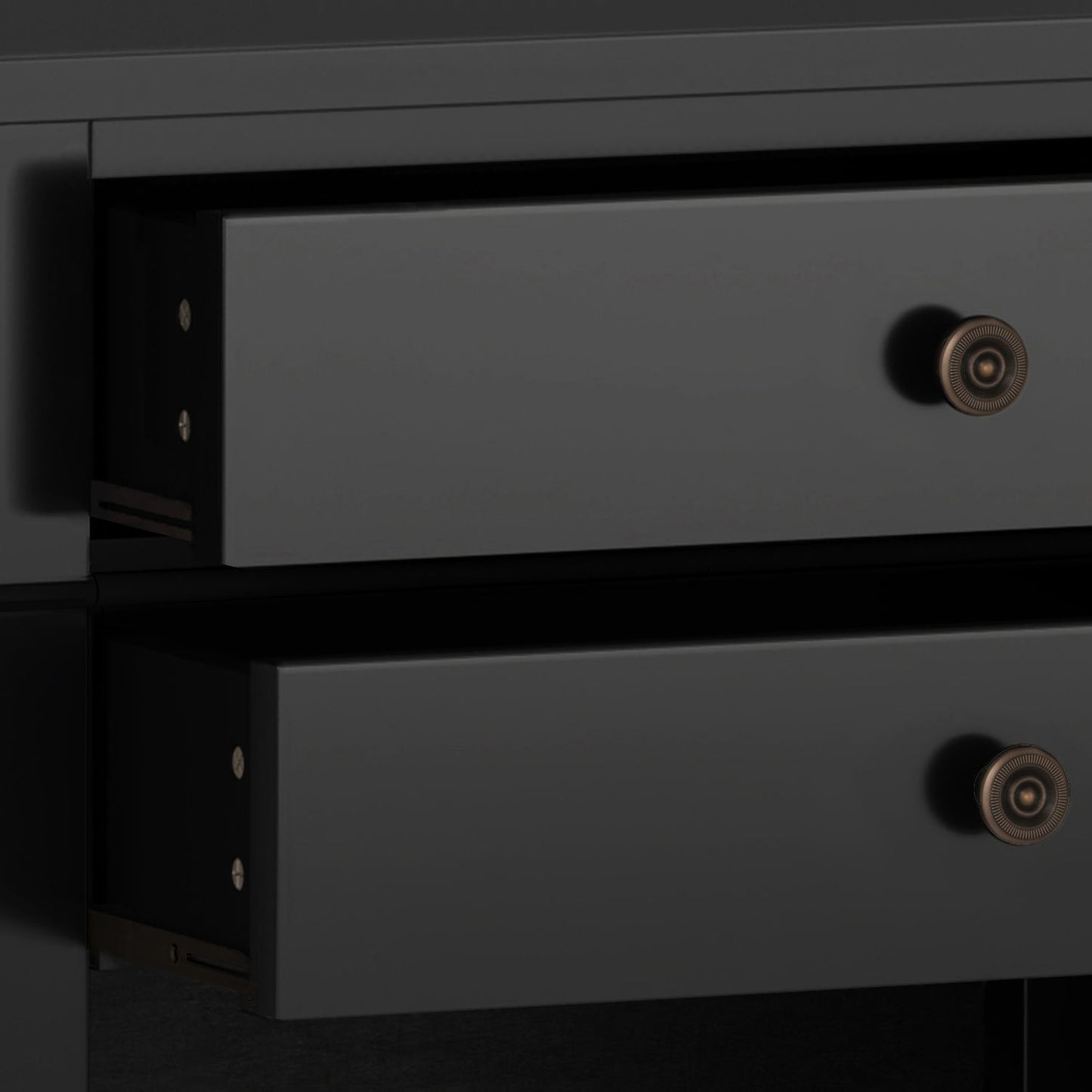 Close-up of two partially open black drawers with round brass knobs on the Carlton - Bedside Table, Handcrafted, showing the side view of the drawer slides and part of the dark cabinet frame.