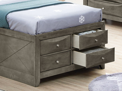 The Marilla Storage Bed with Bookcase Headboard features built-in base drawers, two open to show books and folded clothes. Finished in gray, the bed is topped with a snowflake-patterned blanket.