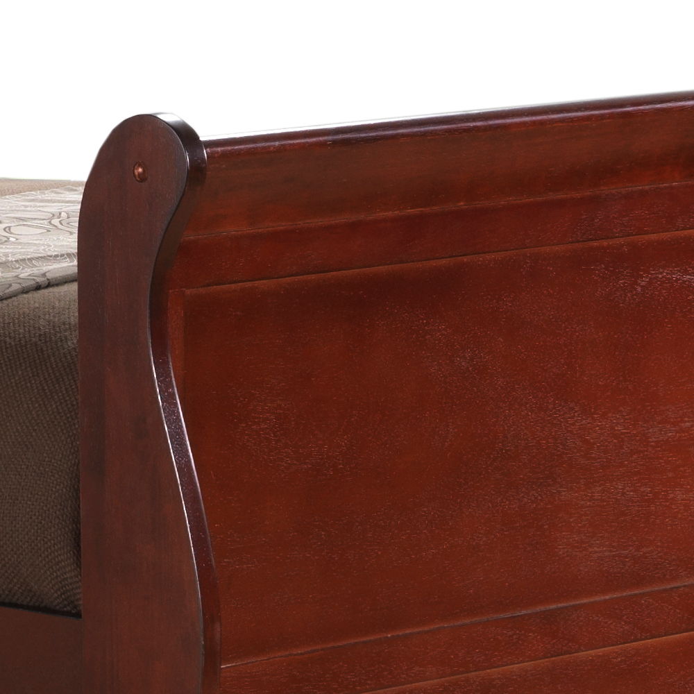 Close-up of the footboard of the Elegant Trundle Bed With Timeless Charm in a rich dark brown finish, with part of a patterned mattress cover visible on the left side.