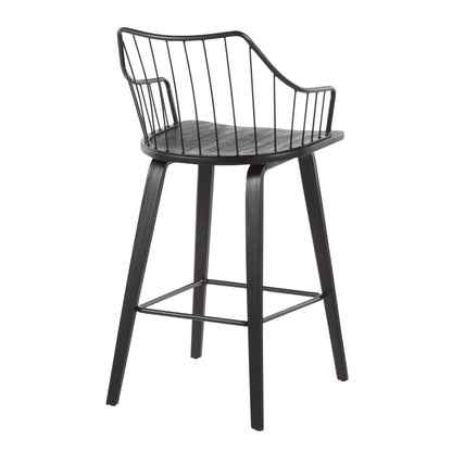The Winston - Farmhouse Counter Stool features a modern black design with a wooden seat, metal wire backrest and arms, and four angled wooden legs joined by a metal footrest.