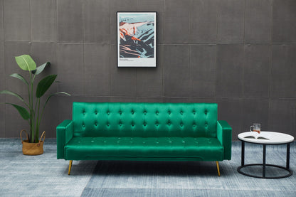 A modern living room features the Comfort Compact Design Sofa Bed in green, a potted plant on the left, a round white coffee table with an open book and glass, and framed abstract art on a gray textured wall.