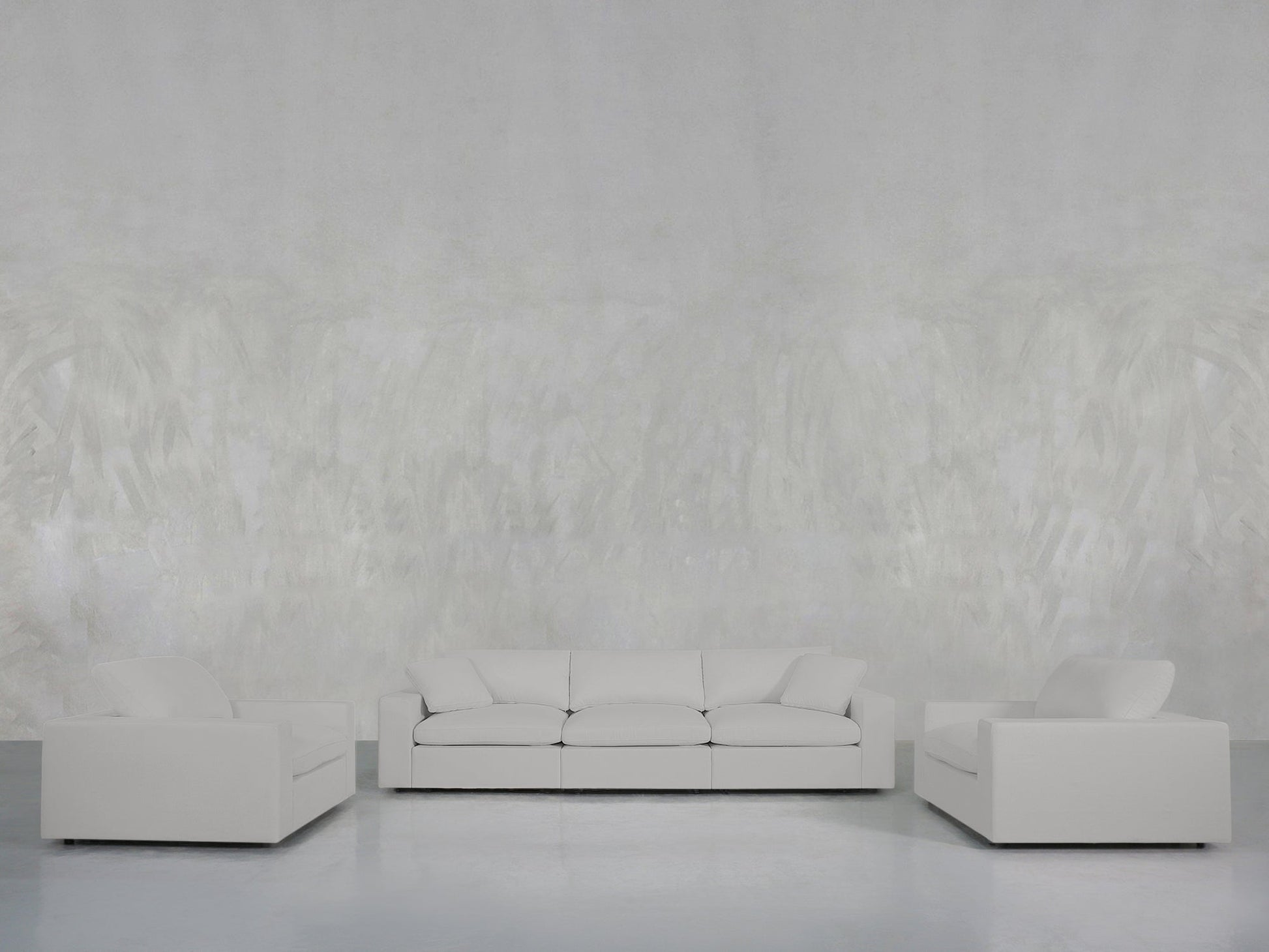 A minimalist living room showcases the 3-1-1 Sofa & Armchair Set with clean lines in white, arranged against a light gray textured wall and a smooth gray floor.