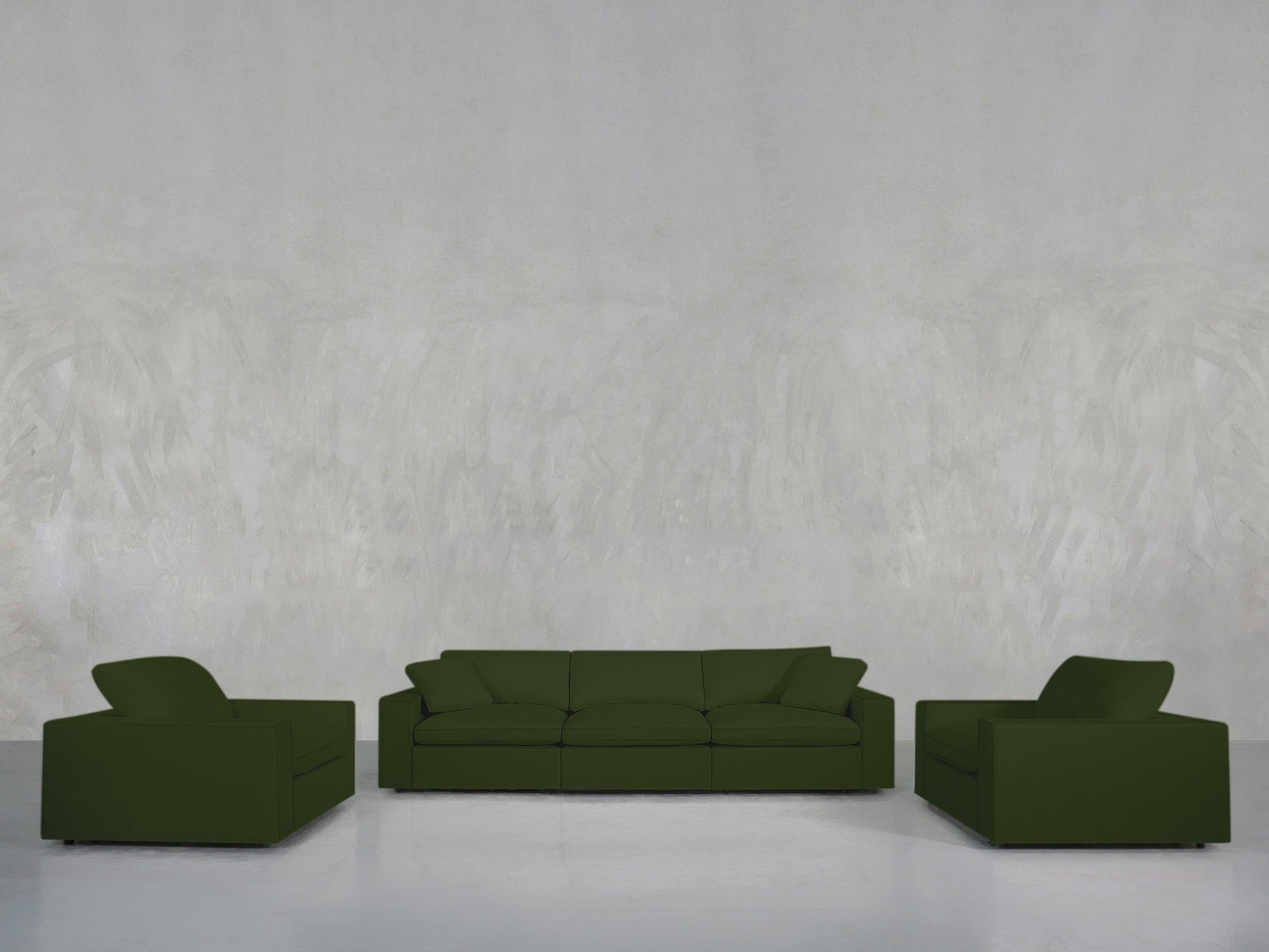 The 3-1-1 Sofa & Armchair Set in dark green is arranged in a minimalistic, spacious room with a pale textured wall and glossy white floor, creating an uncluttered scene that highlights the furniture and open space.