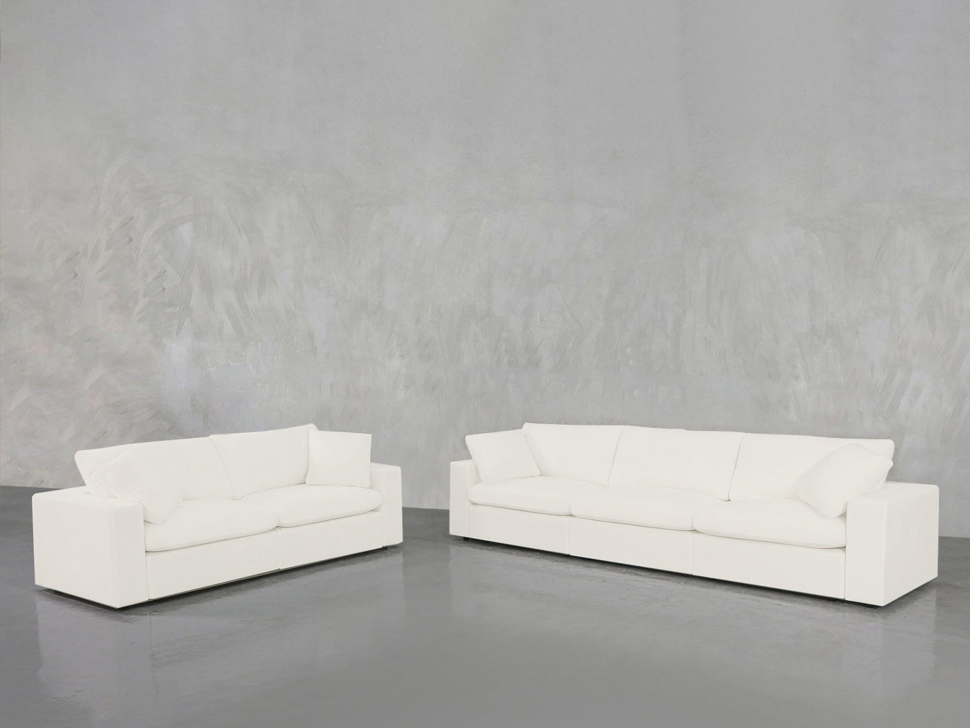 A modern 3-2 Sofa Set in white is arranged on a shiny gray floor against a textured light gray wall.