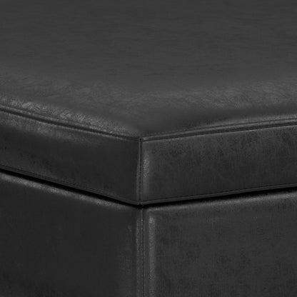 Close-up of the corner of the Owen Multifunctional Square Coffee Table Storage Ottoman, highlighting its black leather-like upholstery, textured surface, and detailed stitching along the edges.