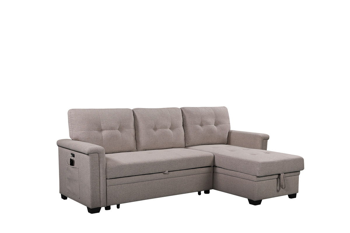 The Nathan Reversible Sleeper Sectional Sofa features light gray upholstery, tufted cushions, a storage chaise, USB charging ports, a side pocket on the left armrest, and short black legs. Shown against a plain white background.