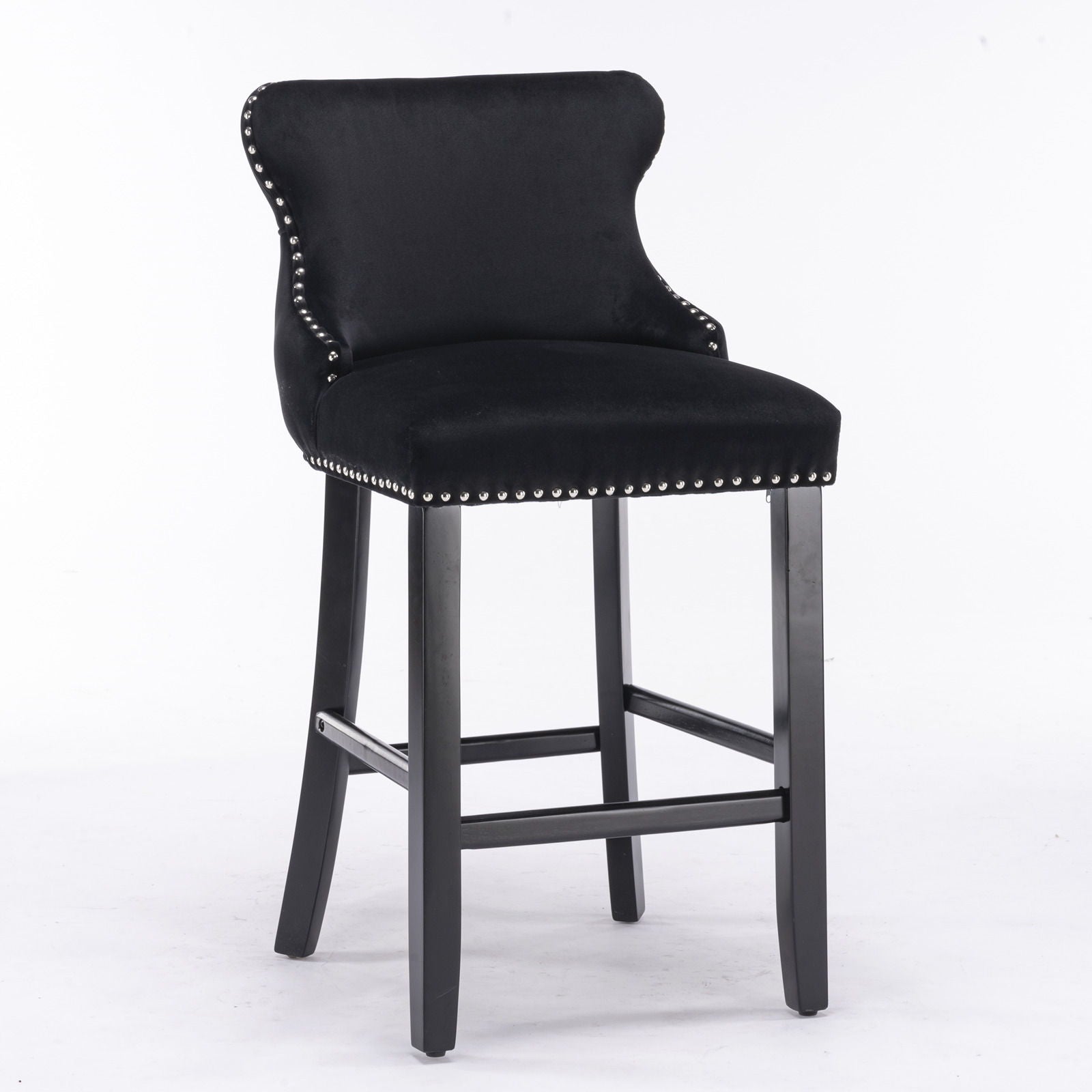 A set of 2 contemporary velvet wing-back barstools with button tufting, chrome nailhead trim, and wooden legs, designed in a leisure style and set against a white background.